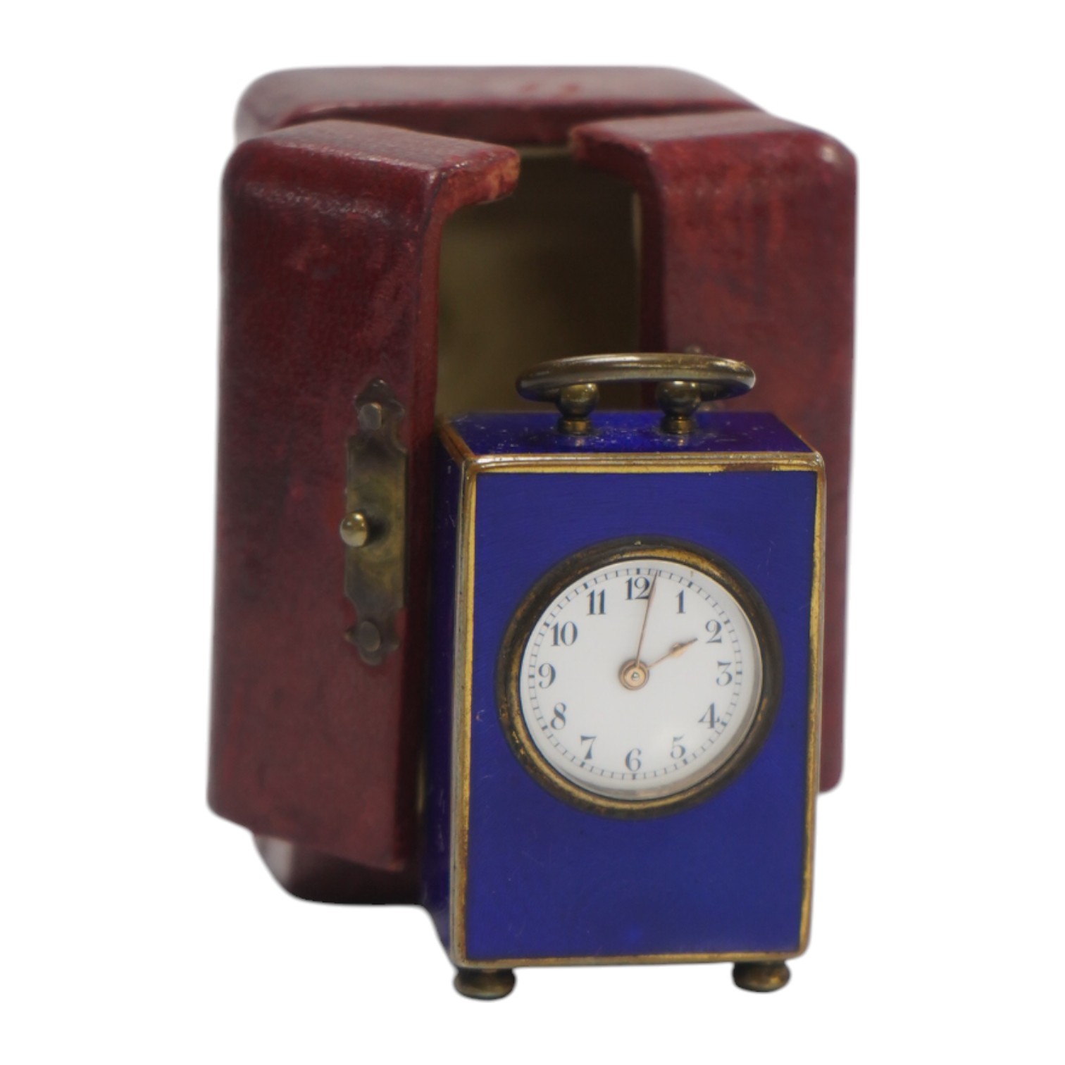 An early 20th century enamelled metal miniature carriage timepiece, cased, 6cm tall. Condition - case poor to fair, clock fair to good